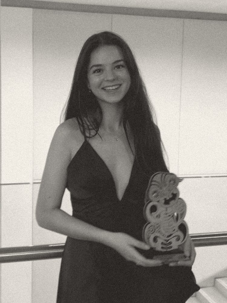 Rebecca holding the World Champions Trophy award